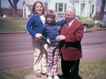 Marghi and Amy Hanneman stand on the carriage stone next to Grandpa Carl F. Hanneman in the 1970s.