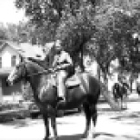 David D. Hanneman prepares to ride a horse in a Mauston parade, circa 1942.