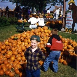 Stevie Hanneman poses before the pumpkin pile at Swan's Pumpkin Farm, circa 1995.