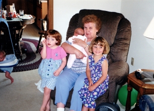 Grandma Mary holding new granddaughter Ruby, 1999. Samantha Hanneman is at left; Abby Hanneman is at right.